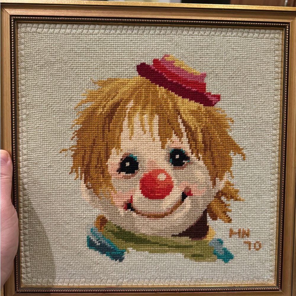 Two well-framed needlepoint clown pictures in gold frames